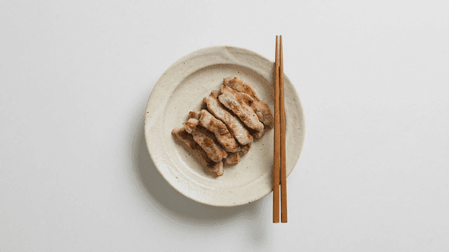 Grilled pork jowl served on ceramic plate
