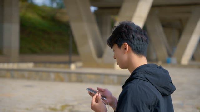 Young man listening to music outdoors