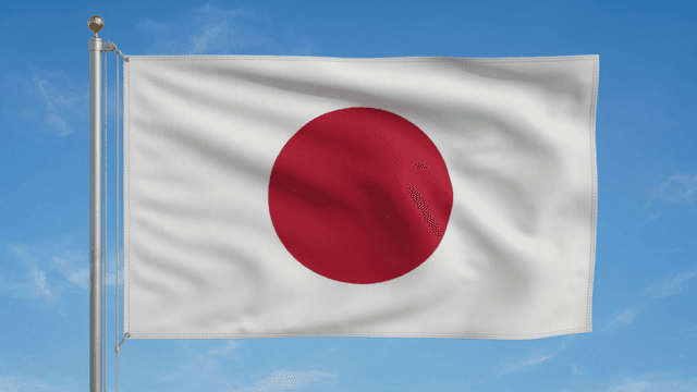 Japanese flag waving against a blue sky