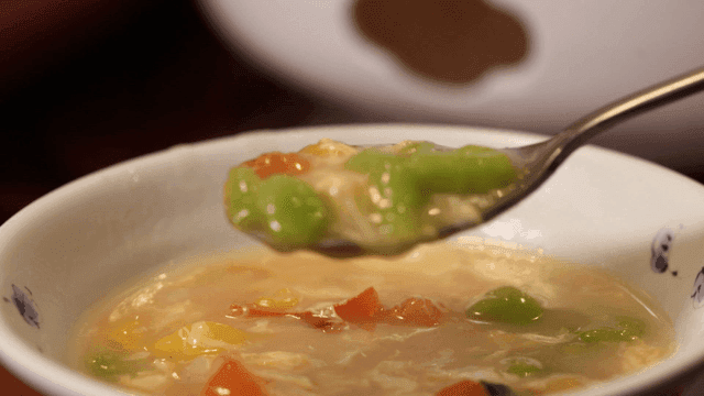 Sujebi vegetable soup scooped out with spoon