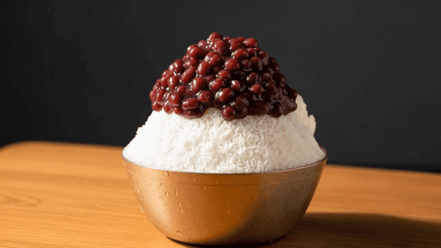 A bowl of shaved ice with red beans