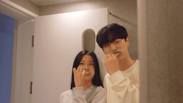 Couple brushing teeth together in bathroom