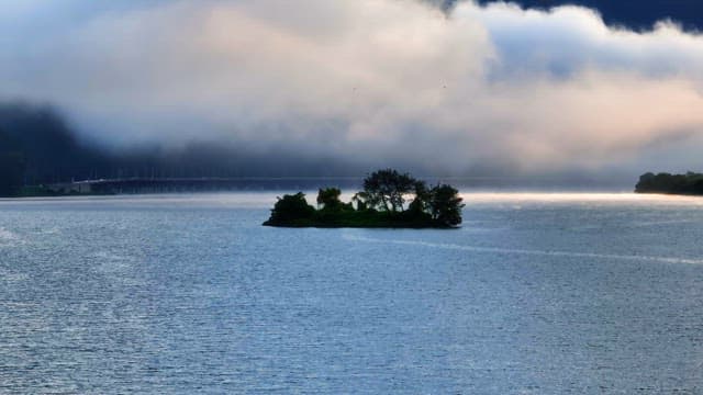 Small island in a misty river