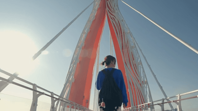 Woman walking on a scenic bridge