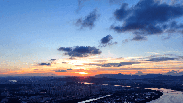 Sunset view of city overlooking river.