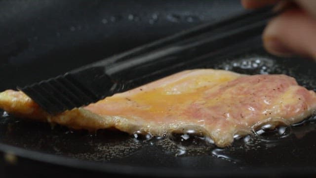 Gloden-brown meat pancake cooked in an oiled frying pan