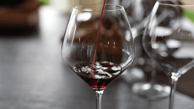 Red wine being poured into a glass