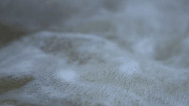 Boiling broth with ingredients in net