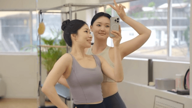 Two women taking a selfie in a fitness studio