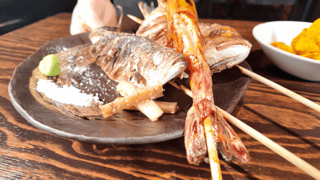 Plate where grilled fish skewers are served
