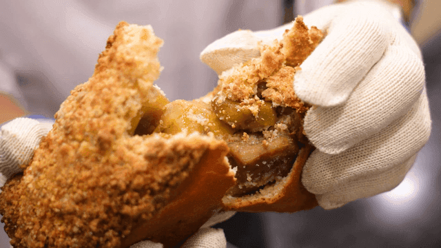 Person splitting chestnut bread