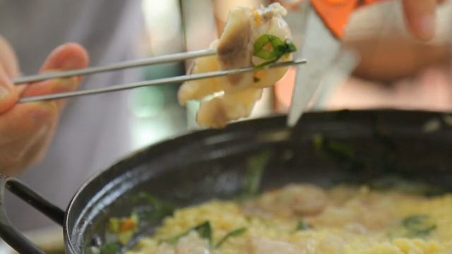 Pot of boiling braised pig's feet soup with ramyeon