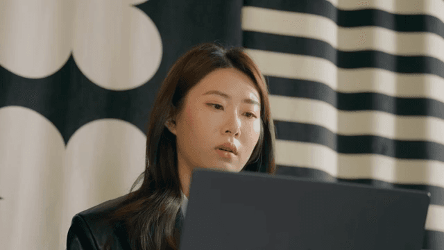 Woman focused on her laptop indoors