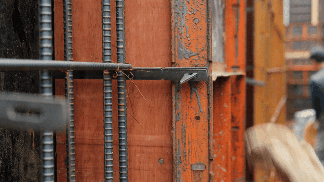 Worker securing rebar at a construction site