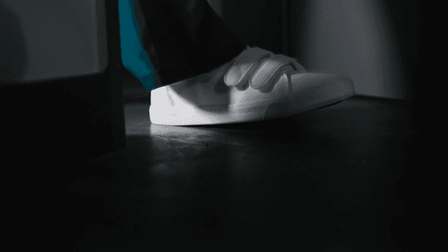 White sneakers in a dimly lit room