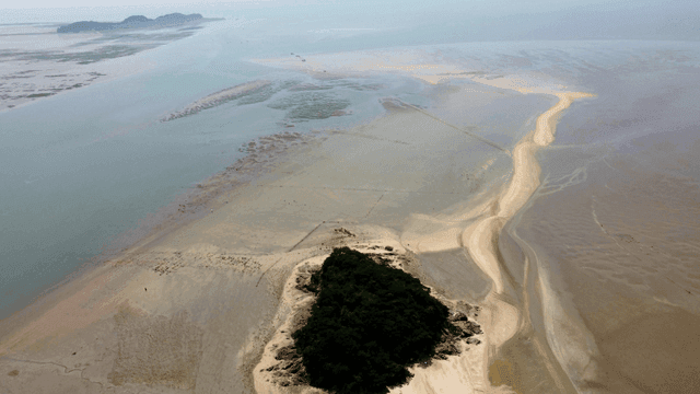 Small island surrounded by mudflats