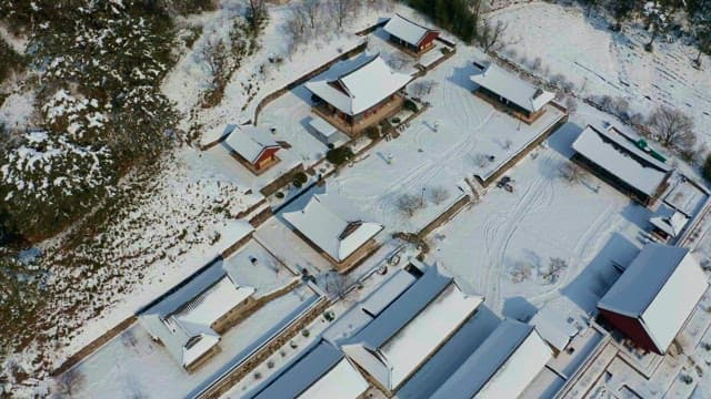 View of a traditional hanok village covered in snow