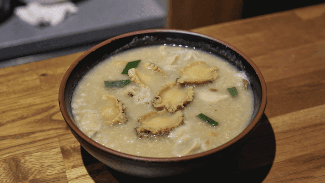 Abalone porridge in a bowl on a table