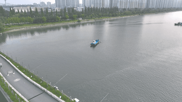 Boats on a river with city skyline