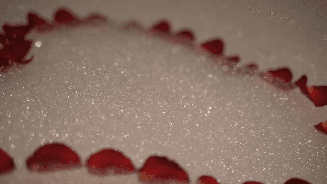 장미 꽃잎으로 하트 모양을 만든 욕조