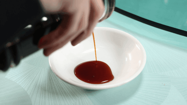 Soy sauce being poured into a white dish