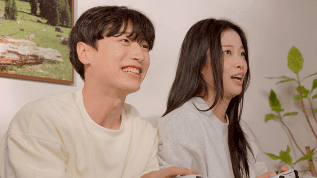 Couple playing console game on sofa