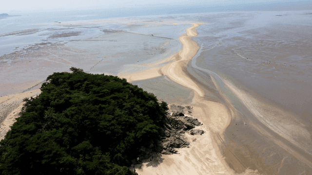 Aerial view of a sandy beach and island