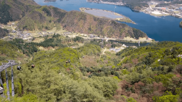 Cable cars over a scenic mountain landscape