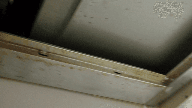 Close-up of dusty and greasy ceiling vent.