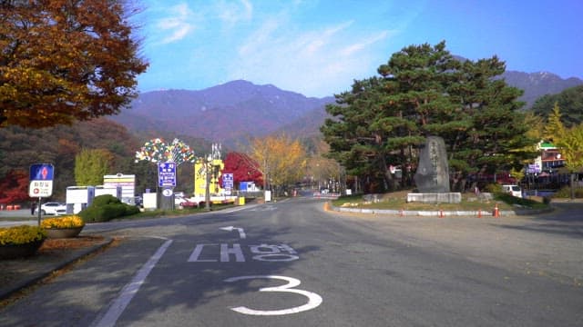 Park entrance road with signage and monument