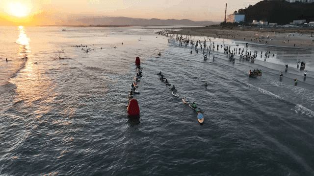 Sunset on beach with surfboards and paddleboards
