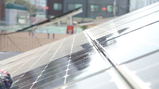 야외 지붕의 태양광 패널을 청소하는 모습