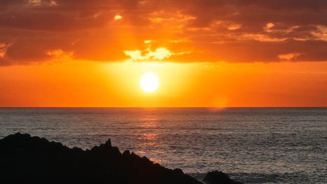 Sunset over the ocean with clouds