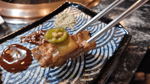 Pickled peppers and pork belly on plate