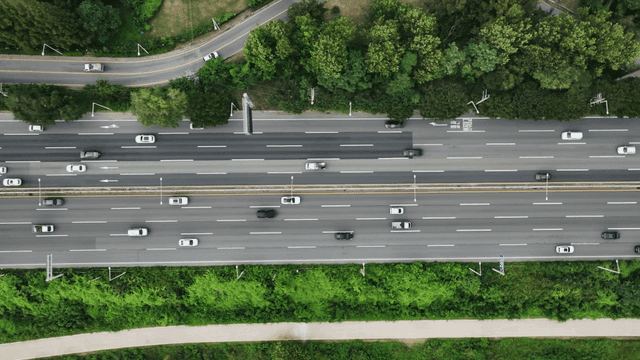 Busy highway surrounded by greenery