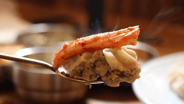 Dumplings with kimchi on spoon