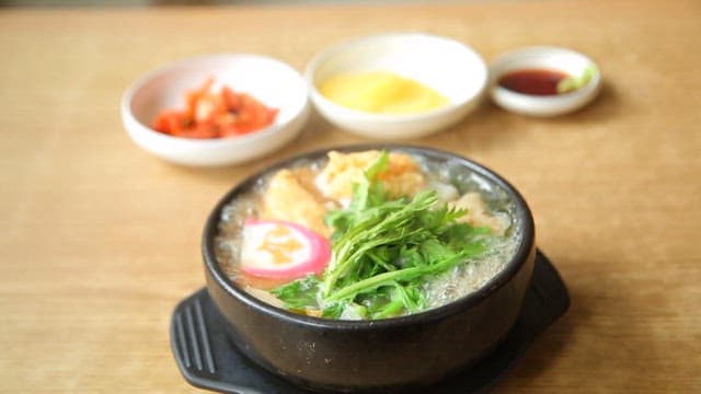 Hot fish cake udon prepared with side dishes on the table