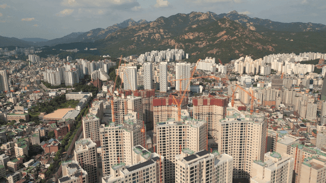 High-rise apartment construction site in city center at foot of mountain