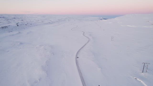 Sunset snowy landscape with winding road