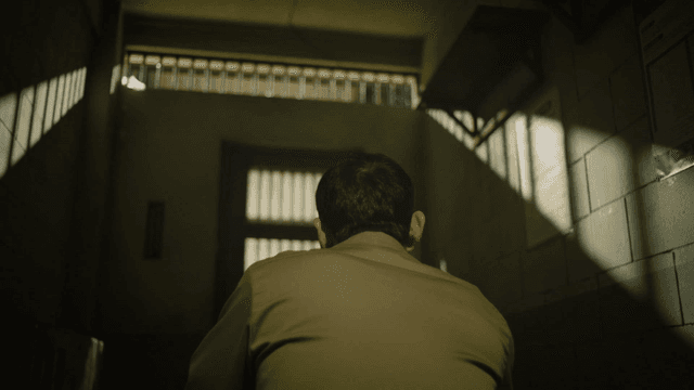 Person in solitary cell with little light