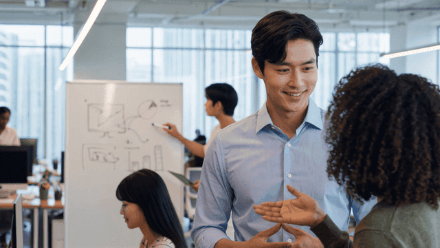 Office meeting with a whiteboard discussion