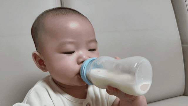 Baby drinking milk from bottle