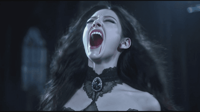 Woman in Gothic attire with vampire fangs