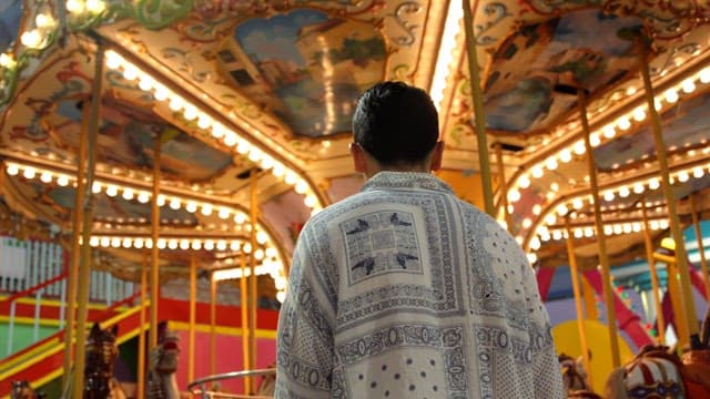 Man standing in front of a carousel