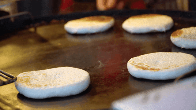 Hotteok cooked on hot iron plate