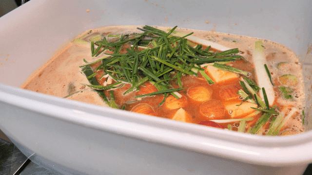 Seasoning container filled with various vegetables and fruits