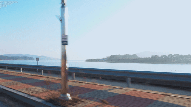 Coastal road with distant island in view