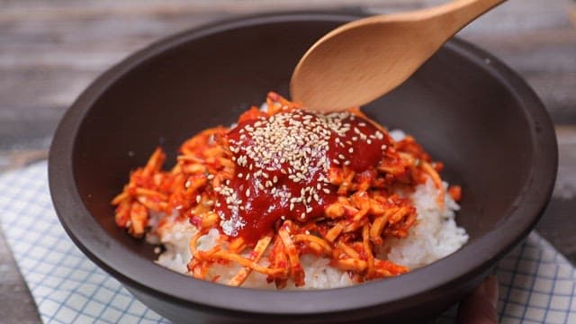 Mixing spicy sweet potato salad with rice