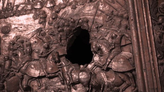 Detailed bronze relief depicting a battle