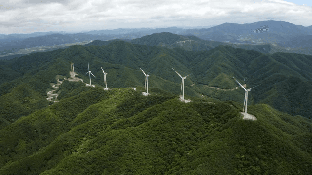 Wind turbines on lush green mountains